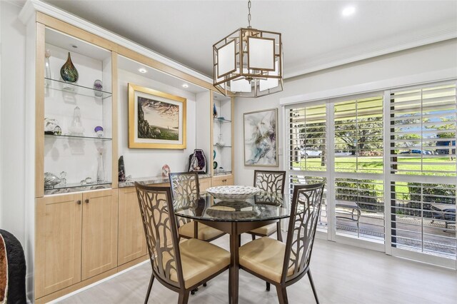 dining room with light wood finished floors, ornamental molding, a notable chandelier, and recessed lighting