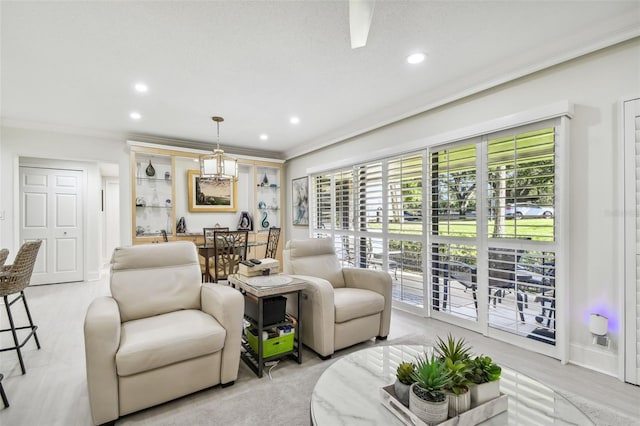 living room featuring a wealth of natural light, crown molding, baseboards, and recessed lighting