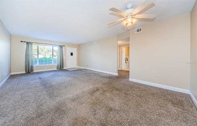 carpeted empty room with ceiling fan and a textured ceiling