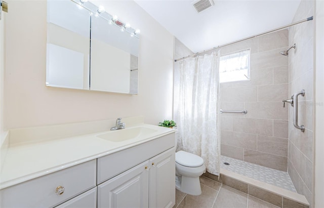 bathroom with tile patterned flooring, vanity, toilet, and a shower with shower curtain