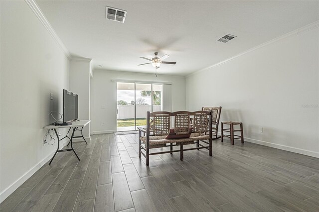 interior space with ornamental molding, dark wood-type flooring, and ceiling fan