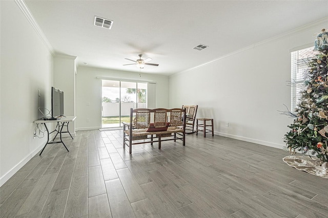 interior space featuring crown molding, wood-type flooring, and ceiling fan