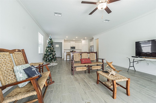 living room featuring ornamental molding, ceiling fan, and light hardwood / wood-style floors