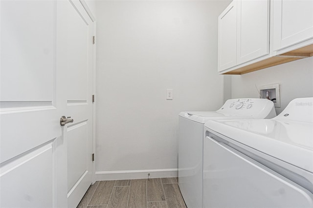 washroom featuring cabinets and washing machine and dryer