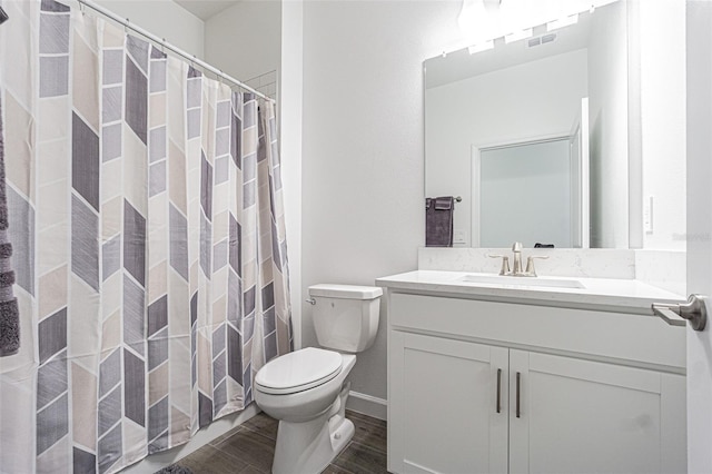 bathroom with vanity, hardwood / wood-style flooring, and toilet