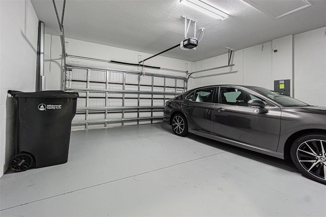 garage with a garage door opener and electric panel