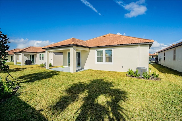 back of property featuring a yard, a patio area, and central air condition unit