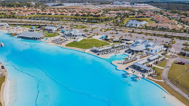 drone / aerial view with a water view and a beach view