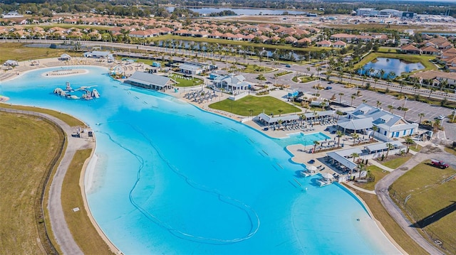 birds eye view of property featuring a water view and a beach view