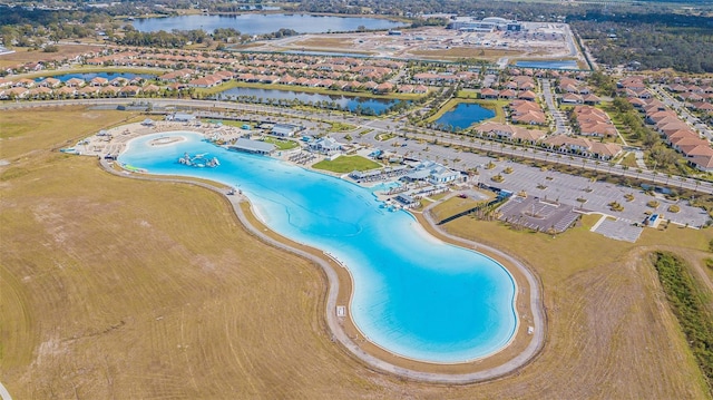 aerial view with a water view and a beach view