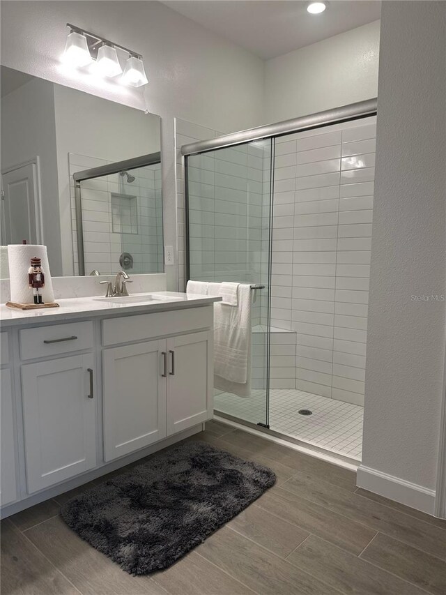 bathroom featuring vanity and an enclosed shower