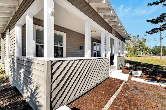 view of side of property with covered porch