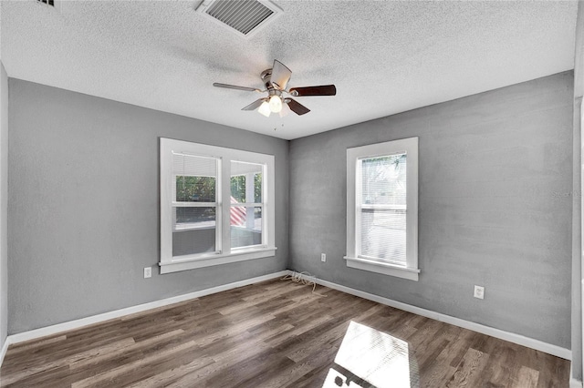 unfurnished room featuring ceiling fan, dark hardwood / wood-style flooring, and a textured ceiling