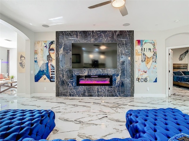 bedroom featuring a high end fireplace, ceiling fan, and tile walls