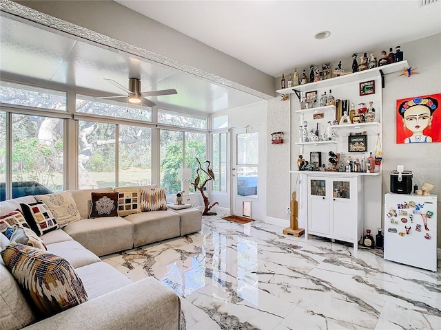 living room featuring bar area and ceiling fan