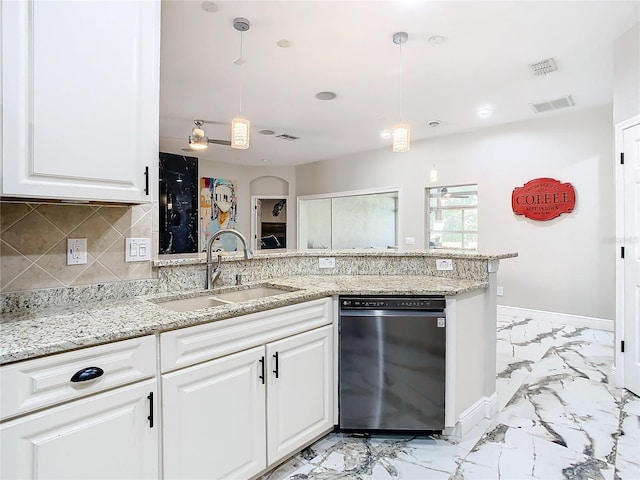 kitchen with pendant lighting, dishwasher, white cabinetry, and sink