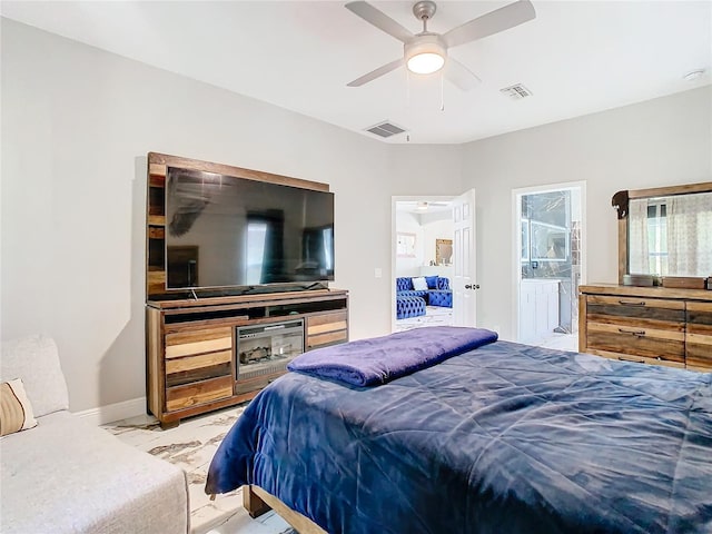 bedroom with ensuite bath and ceiling fan