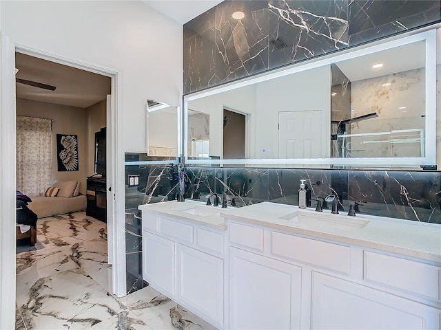 bathroom featuring vanity, ceiling fan, an enclosed shower, and backsplash