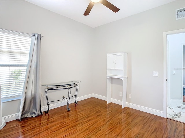 spare room featuring hardwood / wood-style flooring and ceiling fan