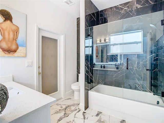 full bathroom with shower / bath combination with glass door, vanity, and toilet