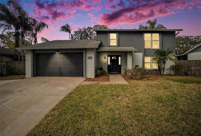 view of front of property featuring a yard and a garage