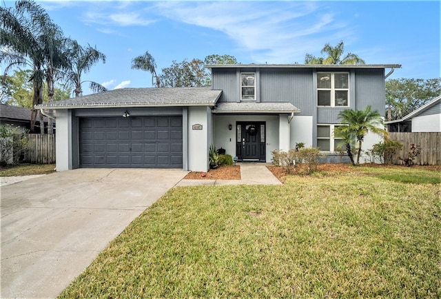 view of property with a garage and a front lawn