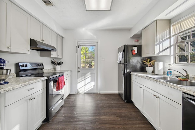 kitchen featuring appliances with stainless steel finishes, white cabinetry, dark wood-type flooring, and sink