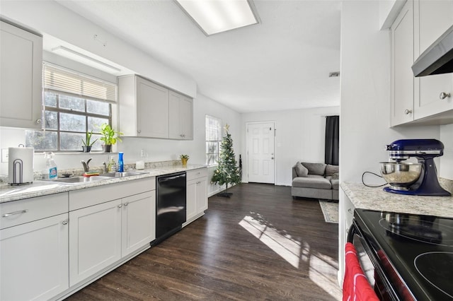 kitchen with sink, dark hardwood / wood-style floors, ventilation hood, white cabinets, and black appliances