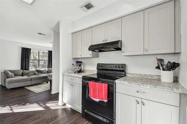 kitchen with electric range, dark hardwood / wood-style floors, and light stone countertops