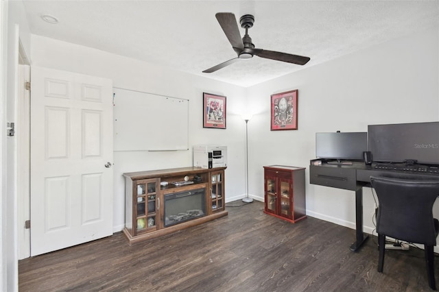 home office featuring a textured ceiling, ceiling fan, and dark hardwood / wood-style floors