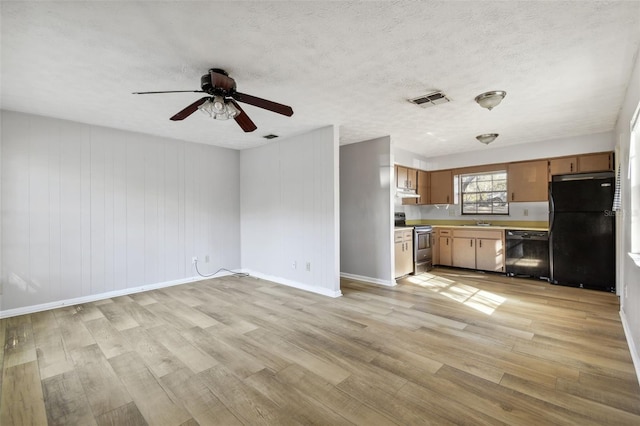 kitchen featuring ceiling fan, sink, black appliances, and light hardwood / wood-style floors