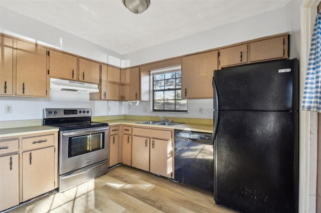 kitchen featuring sink, black appliances, and light hardwood / wood-style floors