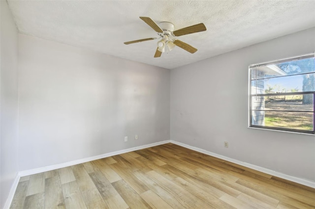 unfurnished room featuring ceiling fan, light hardwood / wood-style floors, and a textured ceiling