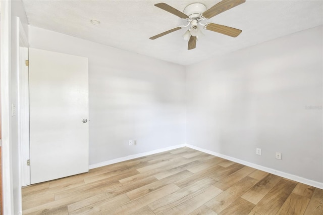 unfurnished room with a textured ceiling, light hardwood / wood-style floors, and ceiling fan