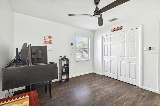 office featuring a textured ceiling, dark hardwood / wood-style flooring, and ceiling fan