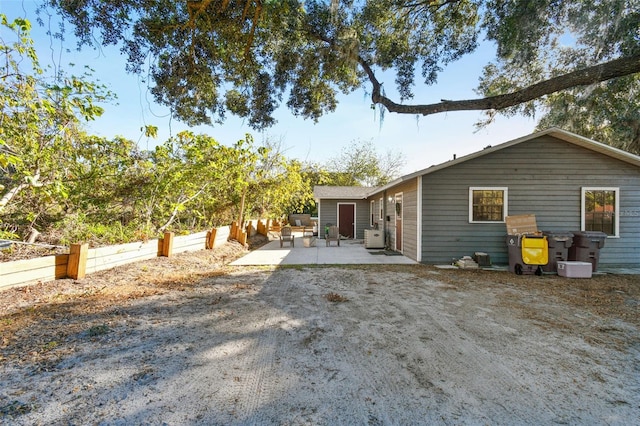 rear view of property featuring a patio area