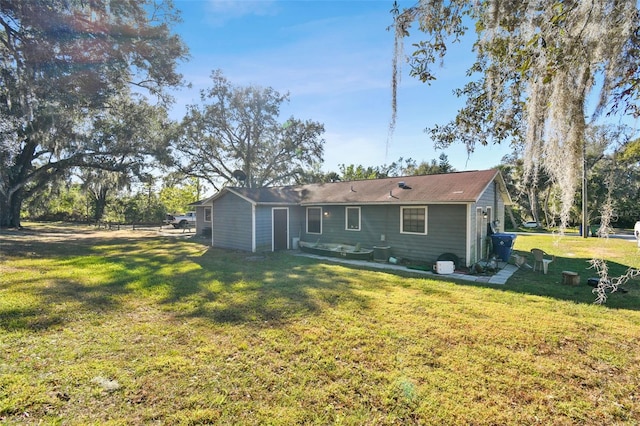 back of property featuring a lawn