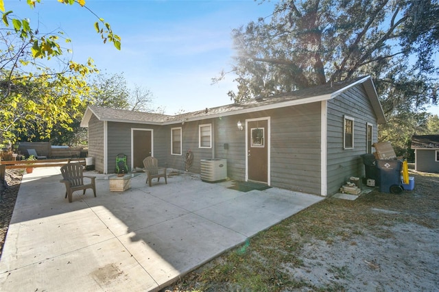 back of property featuring cooling unit and a patio