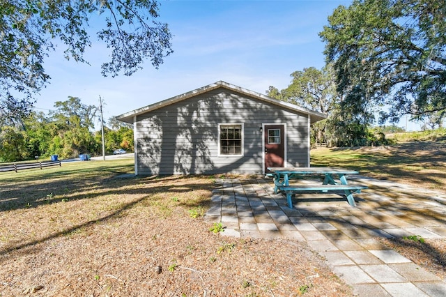 rear view of property with a patio area and a yard