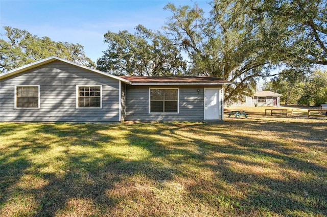 back of house with a yard