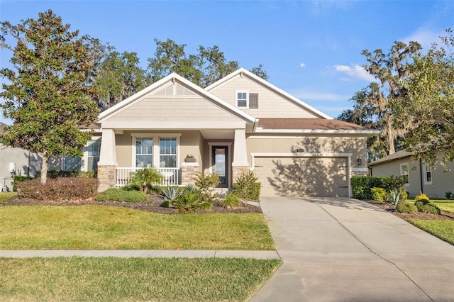 craftsman-style home with a garage, covered porch, and a front lawn