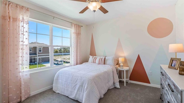 carpeted bedroom with multiple windows and ceiling fan