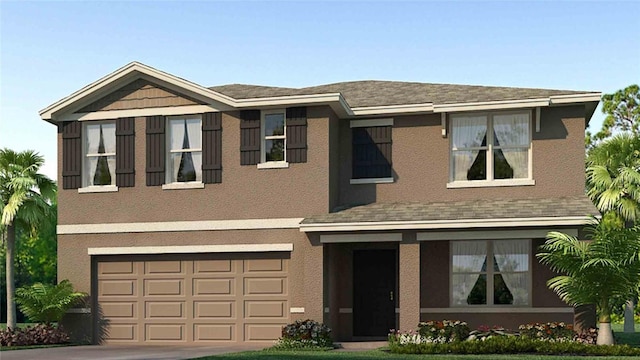 view of front of home featuring a front yard and a garage