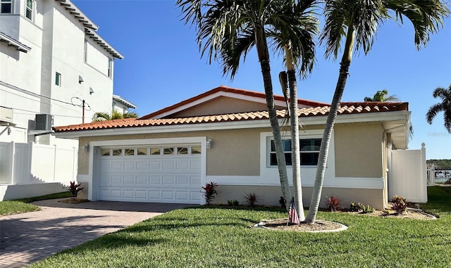 view of front of home featuring a front lawn and a garage