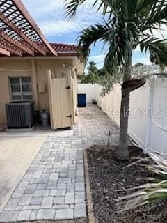 view of patio featuring central AC unit and a pergola