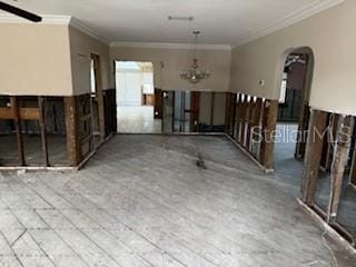 empty room with ceiling fan and ornamental molding