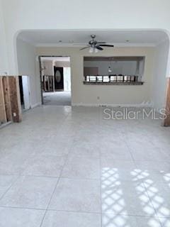 spare room featuring ceiling fan, tile patterned flooring, and ornamental molding