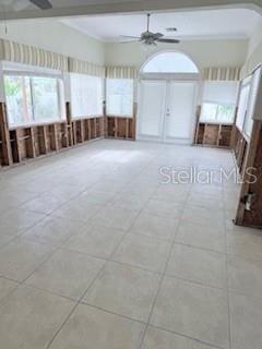 empty room with ceiling fan and light tile patterned flooring