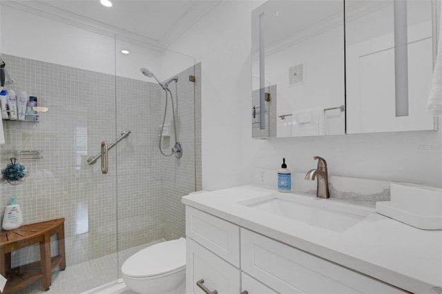 bathroom featuring vanity, toilet, ornamental molding, and walk in shower