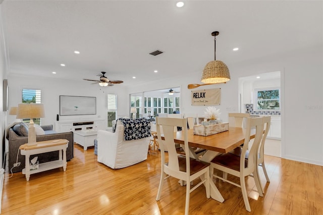 dining room with light wood-type flooring and a wealth of natural light